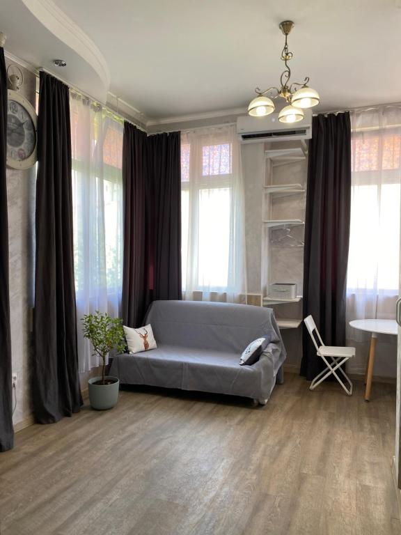a bedroom with a bed and a table and windows at Lucky Space 1 Nice&Cosy Studio in Budva