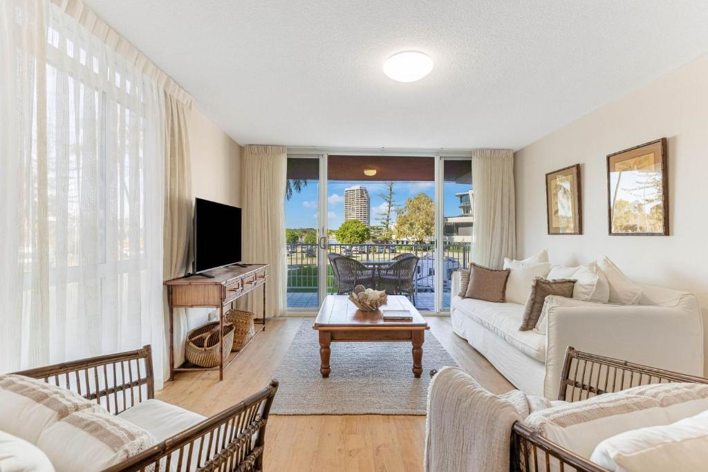 a living room with a couch and a table at Beach Lodge Unit 5 in Gold Coast