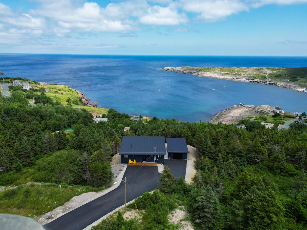 an aerial view of a house next to a body of water at Flatrock Ocean View Sauna 3B 35BA in Flat Rock
