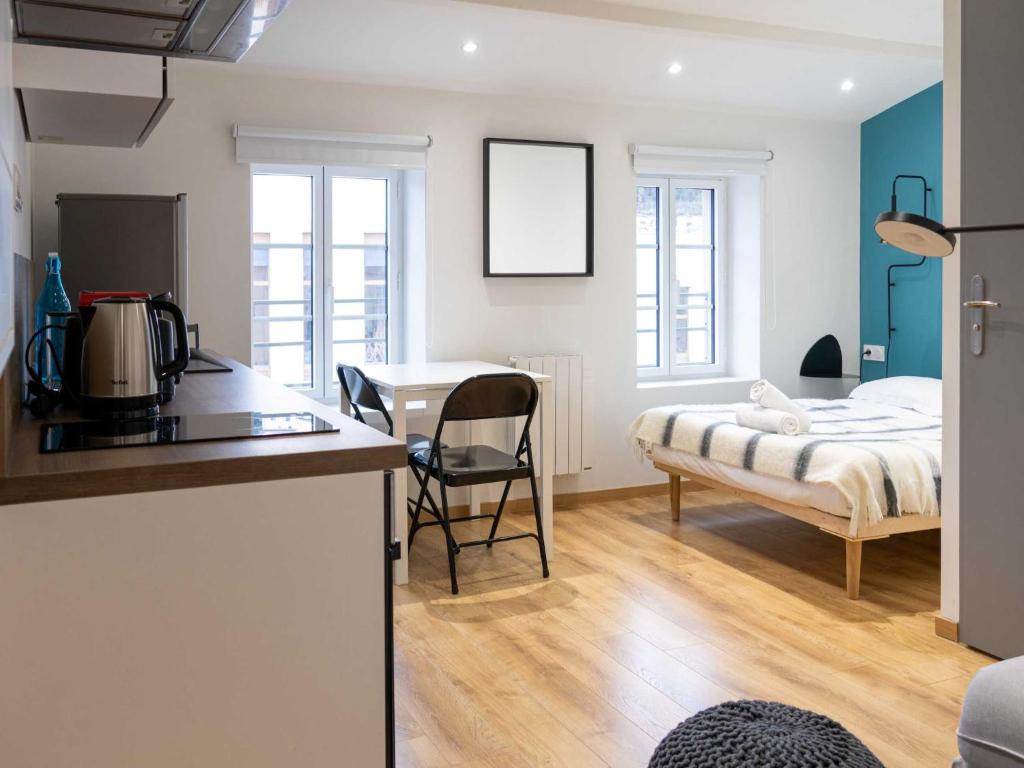 a kitchen and a bedroom with a bed and a table at DIFY Rue des Docks - Vaise in Lyon