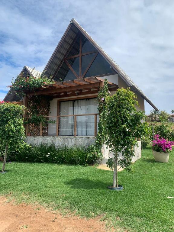 a house with plants on the side of it at Chalé Village da Serra in Serra de São Bento