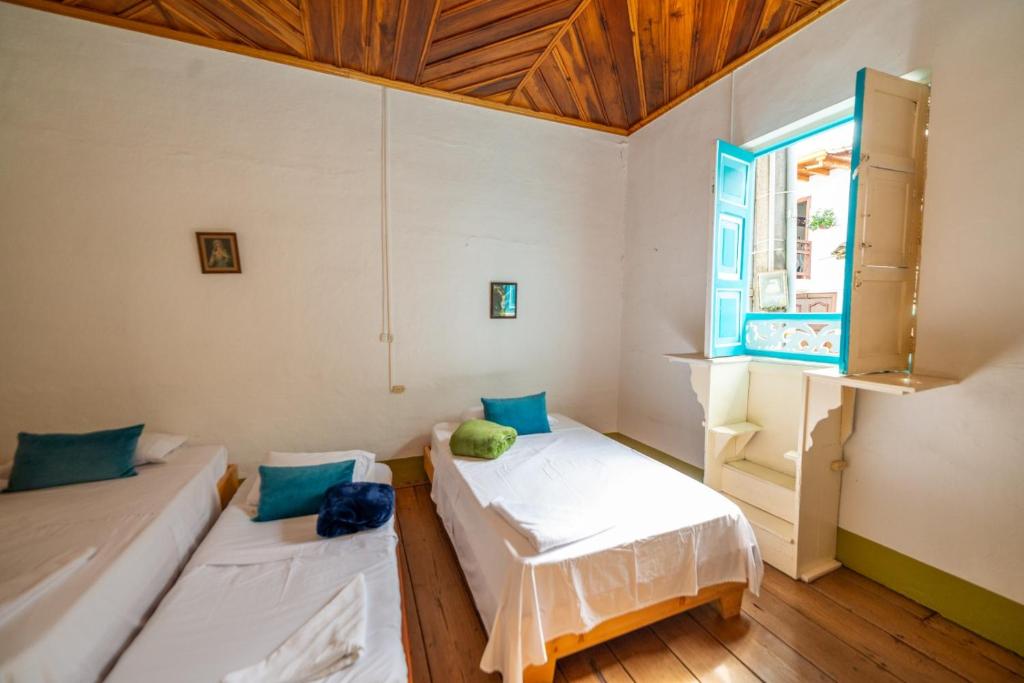 En eller flere senge i et værelse på Casa Hotel Santa Laura Jericó