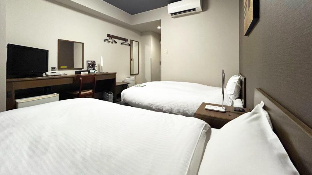 Postel nebo postele na pokoji v ubytování Hotel Route-Inn Myoko Arai
