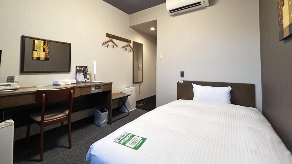 Postel nebo postele na pokoji v ubytování Hotel Route-Inn Myoko Arai