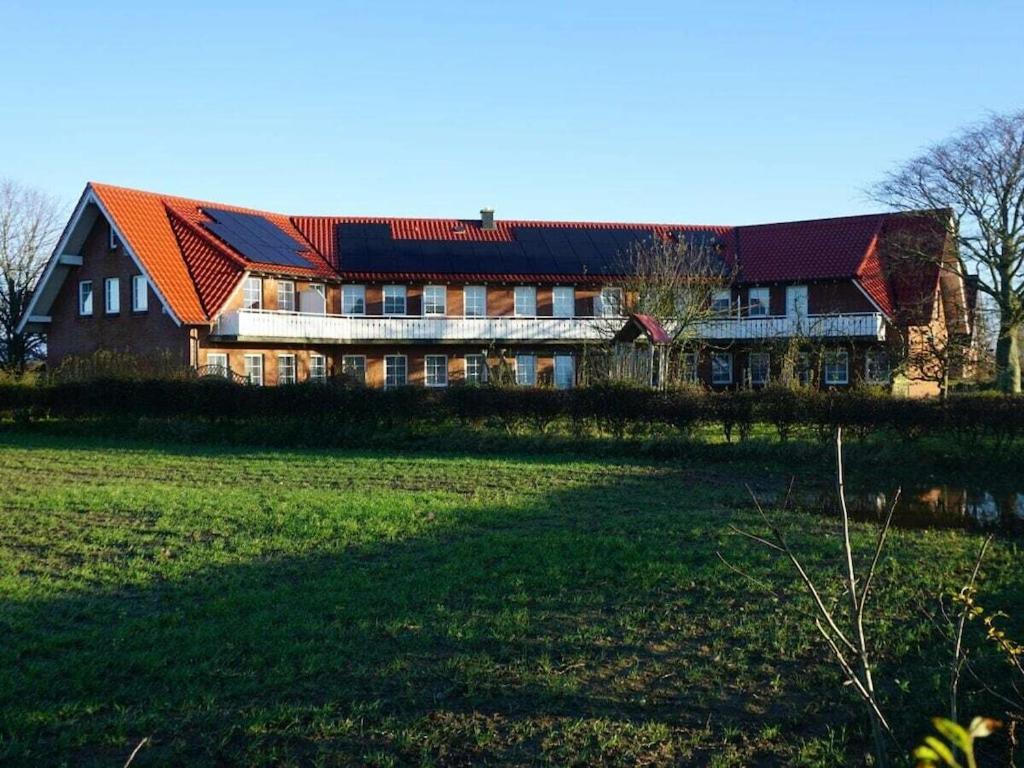 a large house with a large field in front of it at Holiday apartment with 2 bedrooms in Hasselberg