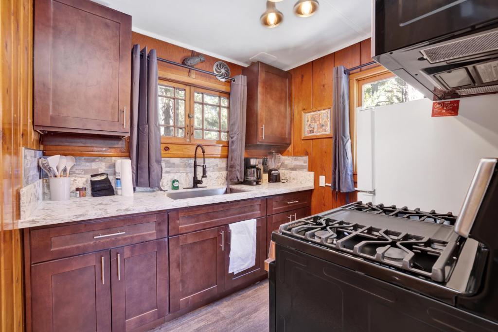 a kitchen with wooden cabinets and a stove at Little pines #102 in Big Bear Lake