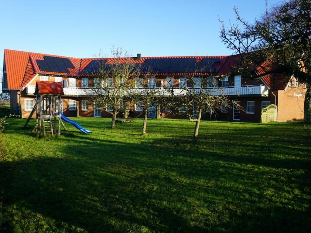 a house with a playground in front of a yard at 1-bedroom holiday apartment in Hasselberg