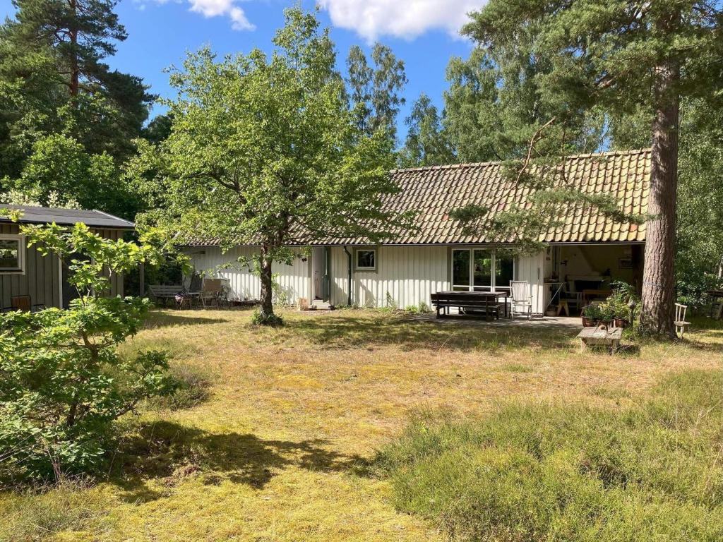 a house with a picnic table in the yard at 4 star holiday home in DEGEBERGA in Degeberga