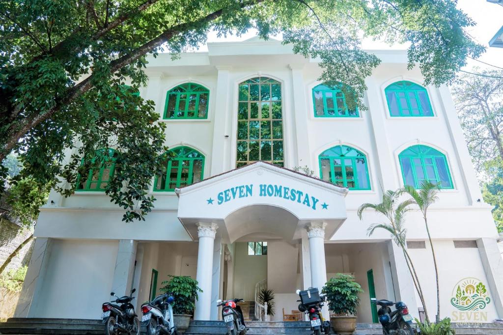 a building with motorcycles parked in front of it at Seven Homestay in Ha Giang