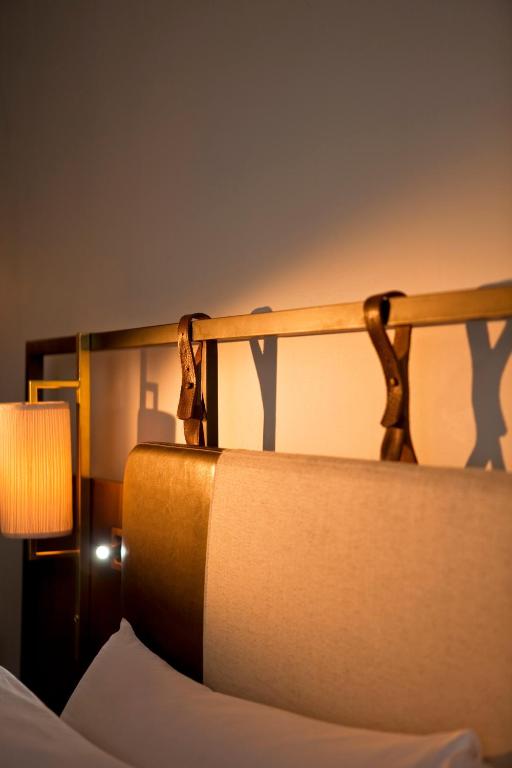 a close up of a bed with a lamp at Refinery Hotel - New York in New York