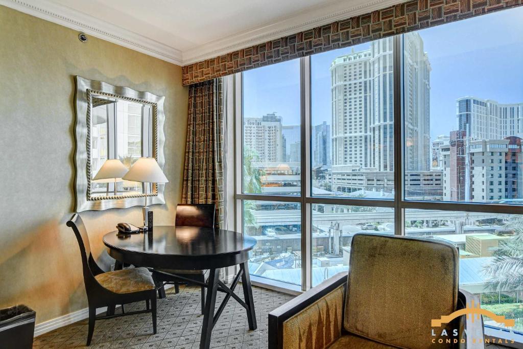 a hotel room with a desk and a large window at MGM Signature-03-611 Strip View Jacuzzi Studio in Las Vegas