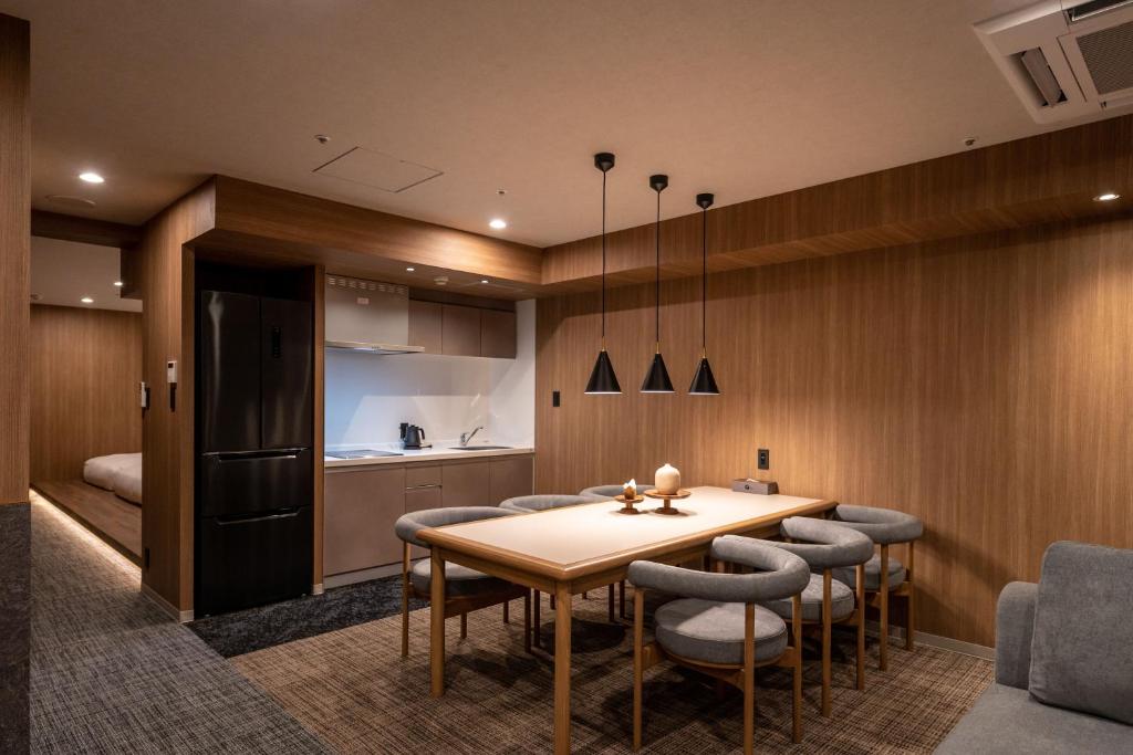 a kitchen and dining room with a table and chairs at Apartment Hotel 11 Dotonbori4 in Osaka