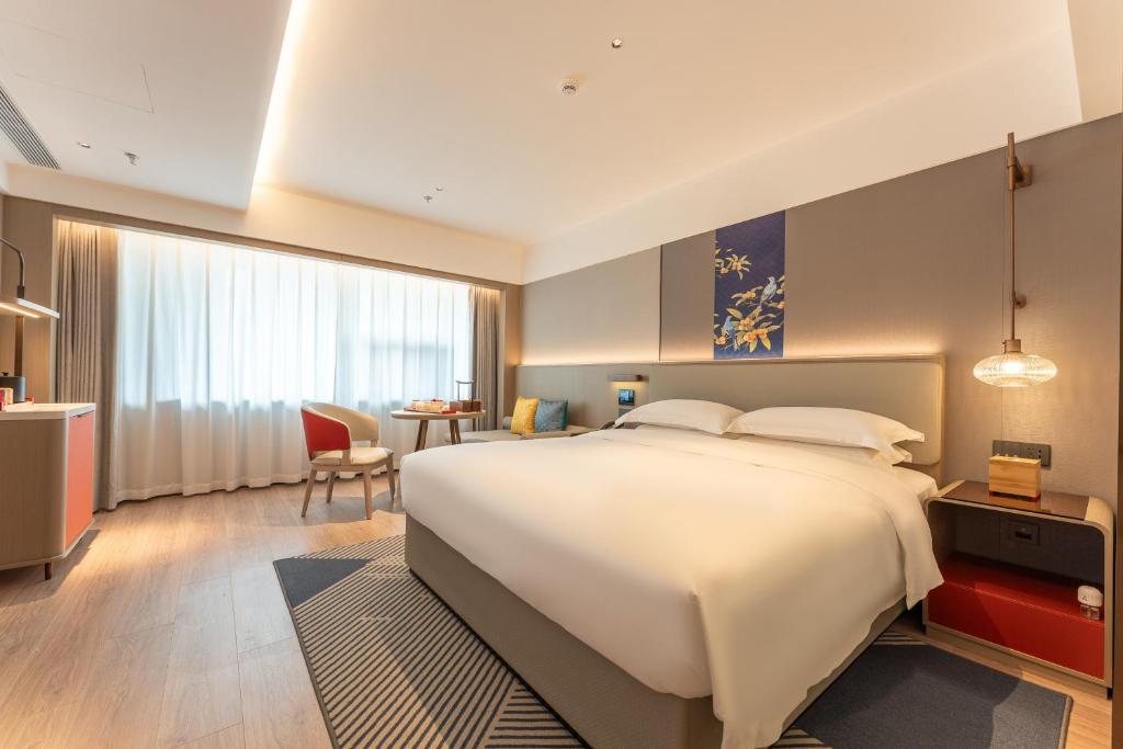 Ένα ή περισσότερα κρεβάτια σε δωμάτιο στο Yicheng Hotel, Jianghan Road Pedestrian Street, Wuhan River Beach