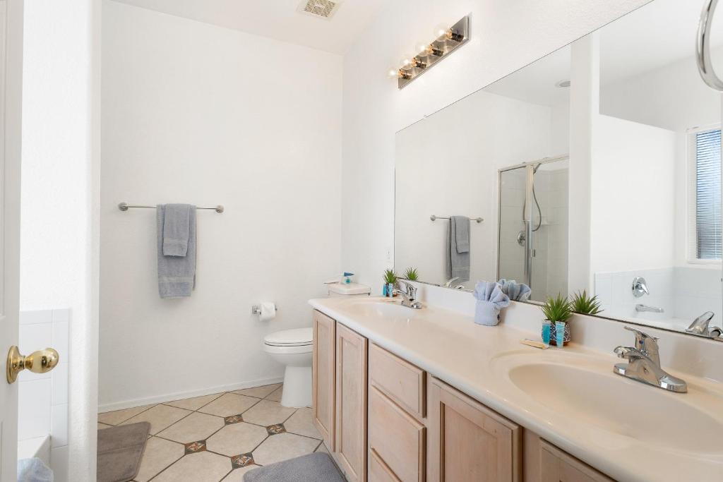 a white bathroom with a sink and a toilet at Sonesta Tucson in Tortolita