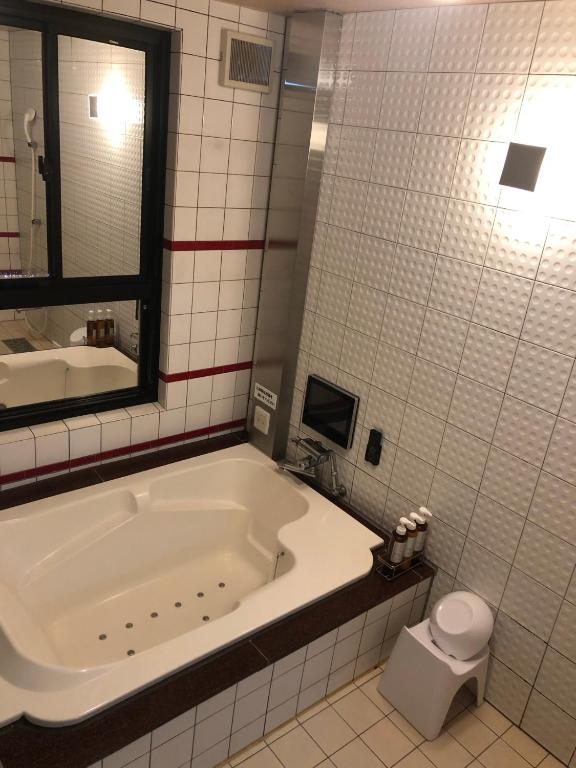 Baðherbergi á ホテルハンズ