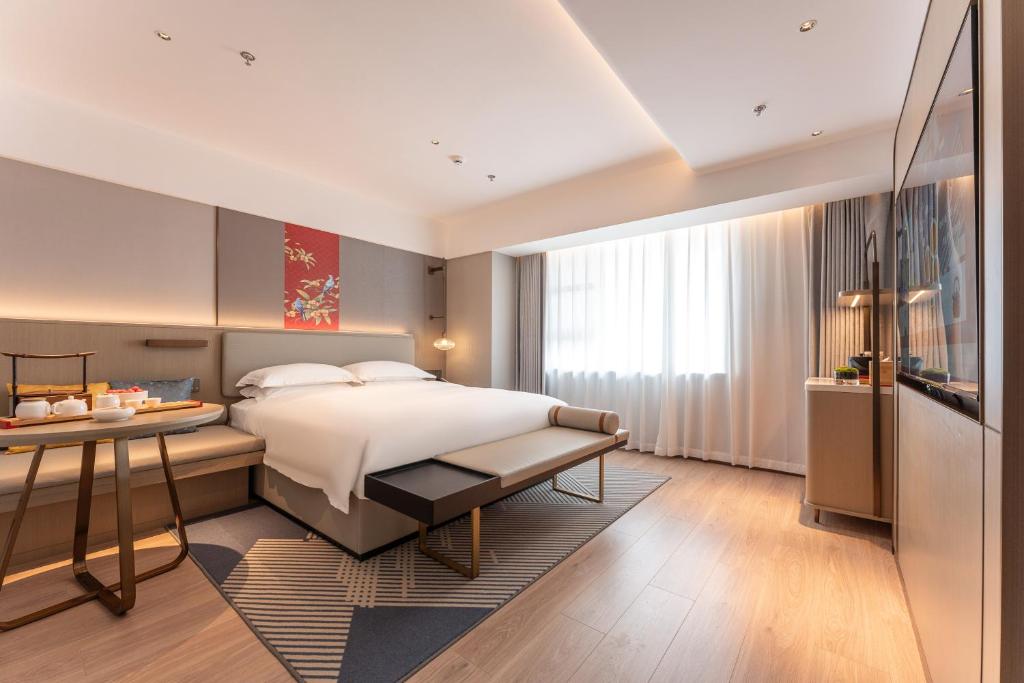 Ένα ή περισσότερα κρεβάτια σε δωμάτιο στο Yicheng Hotel, Jianghan Road Pedestrian Street, Wuhan River Beach