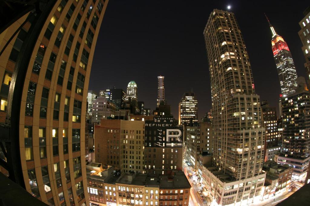 a view of a city skyline at night at Refinery Hotel - New York in New York