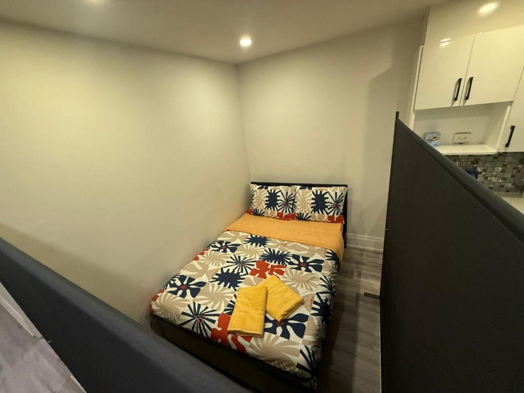 a small bedroom with a bed in the corner at Private Balcony Studio Apartment for 5 People at Queen Street Downtown in Toronto