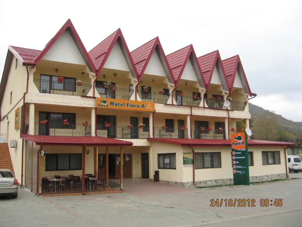 a building with a lot of balconies on it at Motel Flora in Lepşa