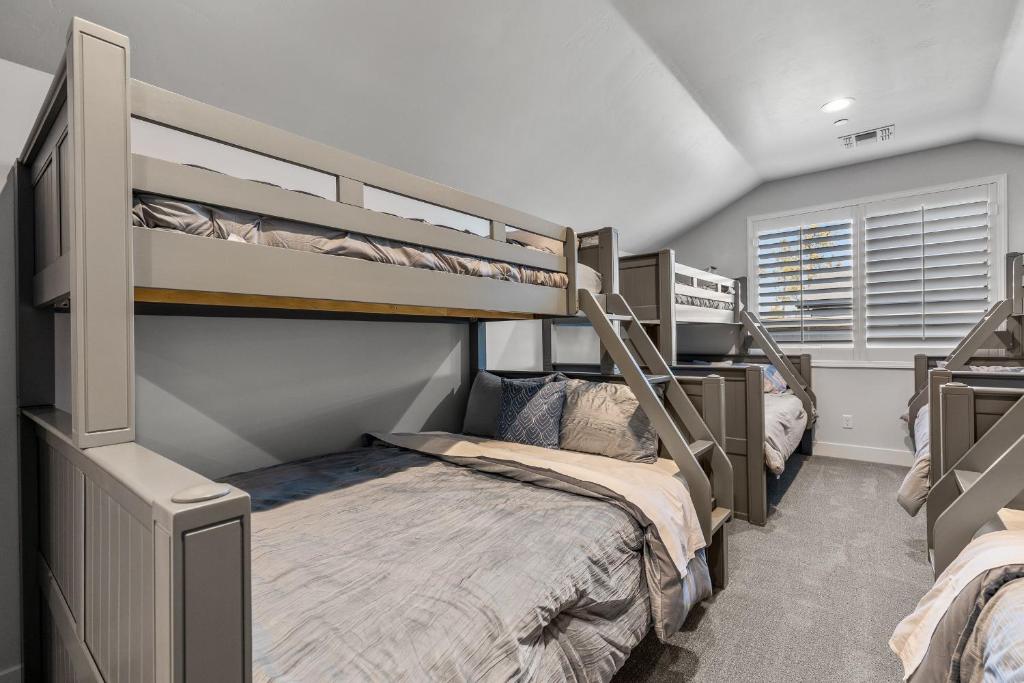 two bunk beds in a room with a bed at Cottonrose Flagstaff in Flagstaff