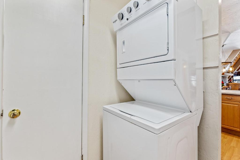 a white refrigerator with its door open in a kitchen at Mescalero Flagstaff in Munds Park