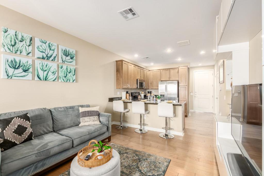 a living room with a couch and a kitchen at Queen Creek #139 Chandler in Chandler