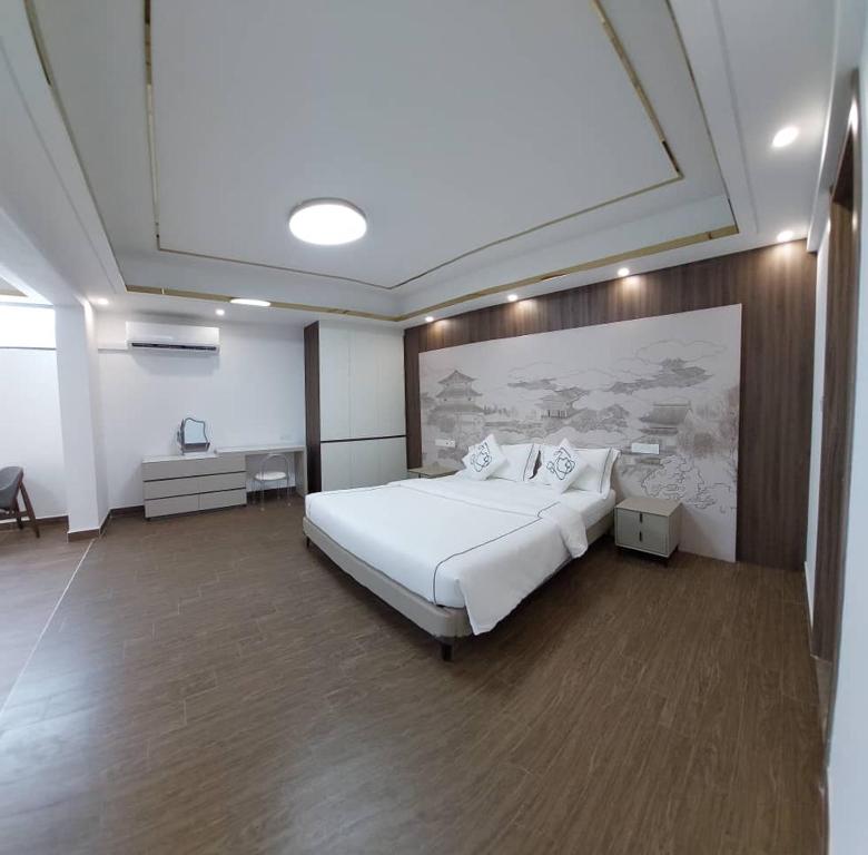 a bedroom with a large white bed in a room at Green Haven Twin Villa at Forestcity-16pax-Netflix in Gelang Patah