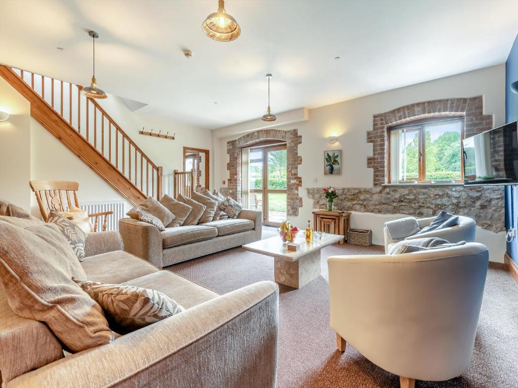 a living room with two couches and a staircase at Leopold - Uk49990 in Blandford Forum