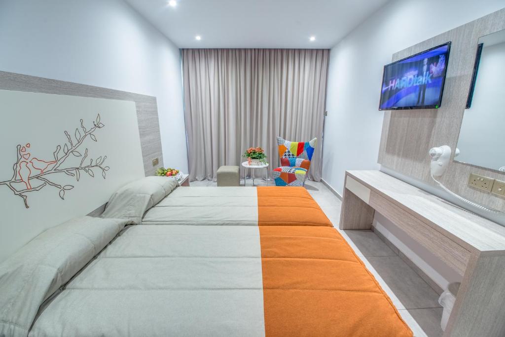 a hospital room with a bed and a flat screen tv at Nicholas Color Hotel in Ayia Napa