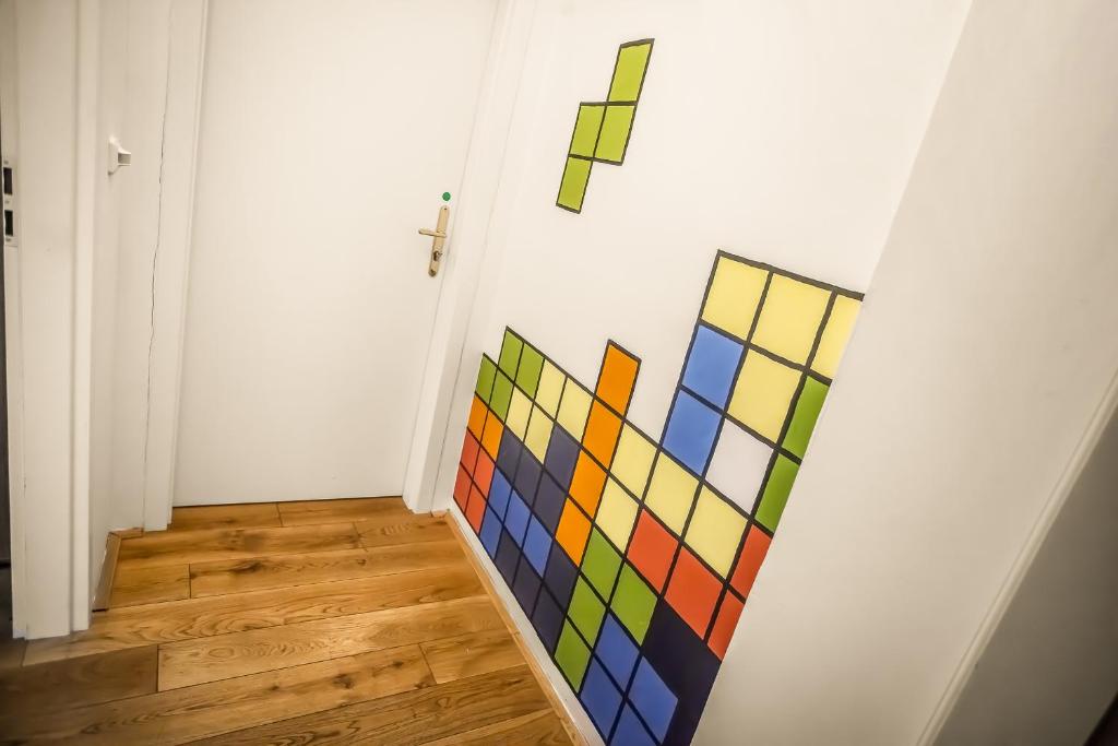 a room with a colorful painting on the wall at Ahoy! Hostel in Prague
