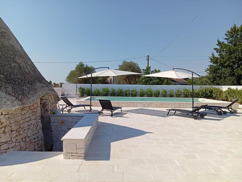 a group of chairs sitting next to a swimming pool at Al Settimo Chilometro in Gioia del Colle