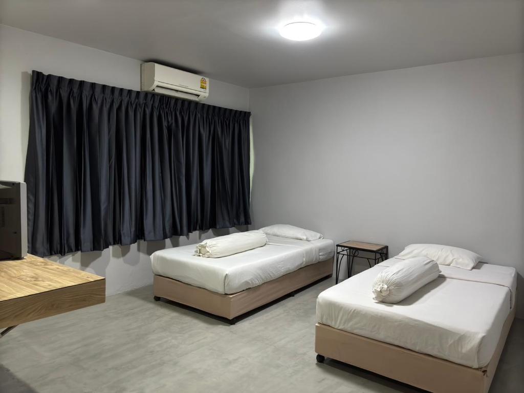 Postel nebo postele na pokoji v ubytování Lithai Guesthouse