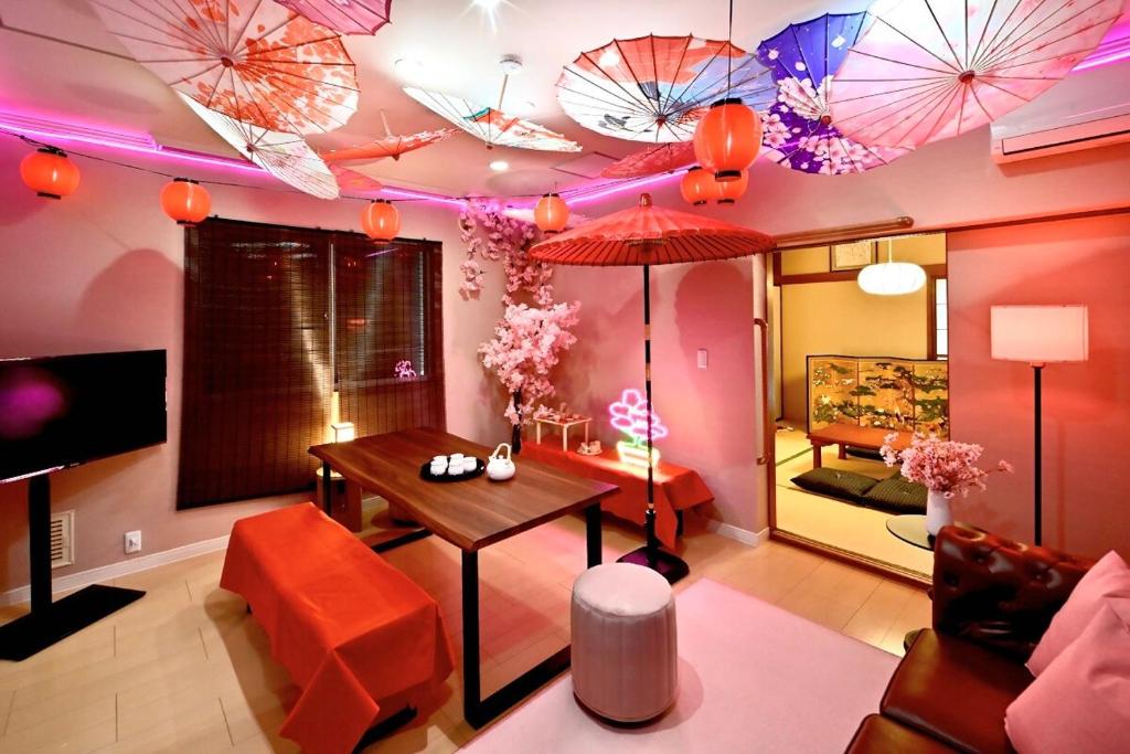 a living room with umbrellas hanging from the ceiling at Otter Stay - Nagoya Castle in Nagoya