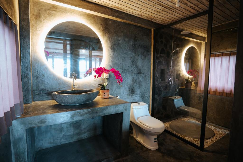 a bathroom with a sink and a toilet at Vila Buruan in Mantaak