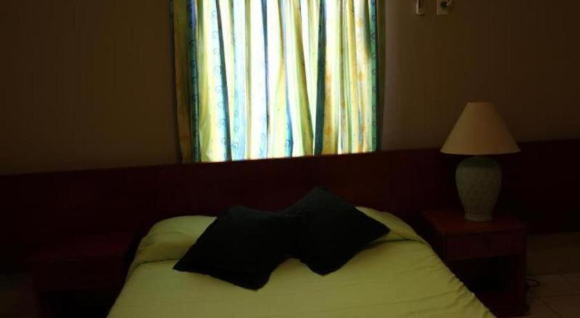 Postel nebo postele na pokoji v ubytování Curacao Lodge
