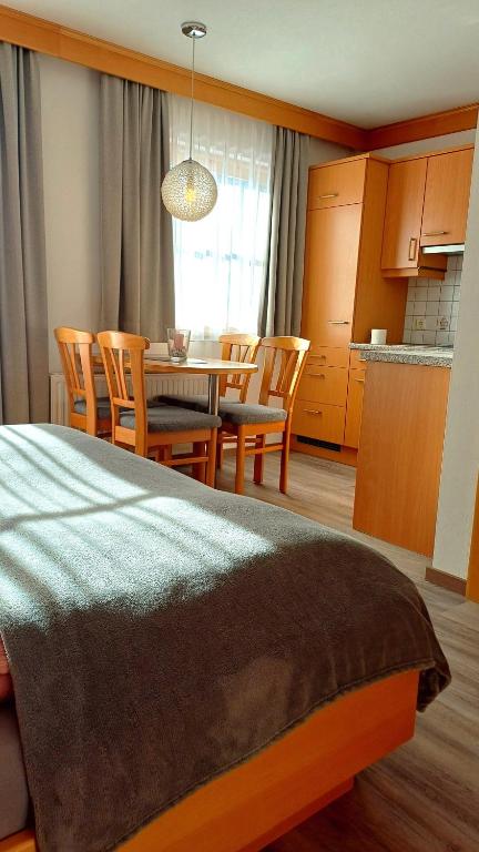 a kitchen and dining room with a table and chairs at Bauernhof Auhof in Wagrain