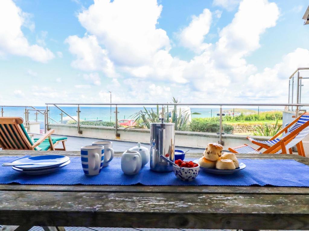 a table with a plate of food on a blue table cloth at 4 Ocean Gate in Newquay