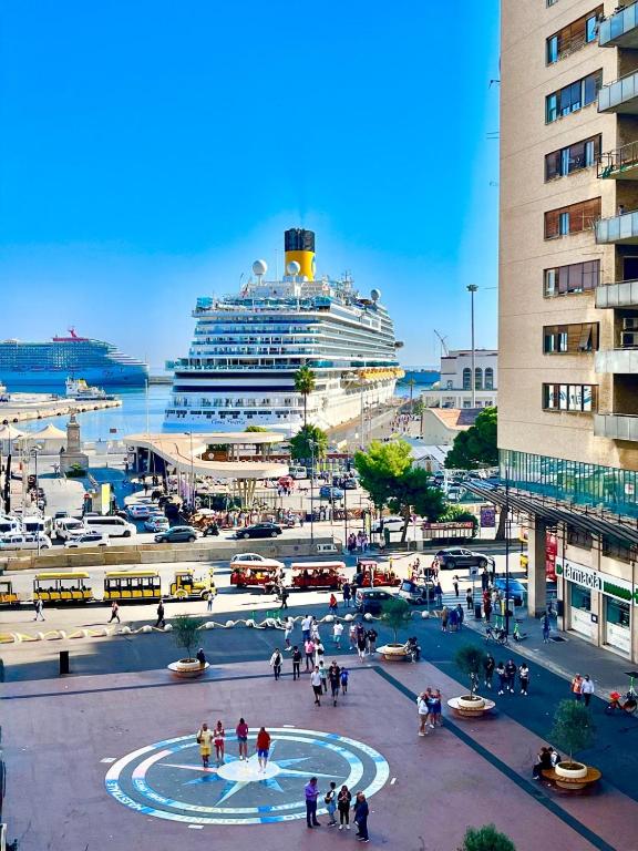 a cruise ship is docked in a harbor with people at Porta Amari B&B in Palermo