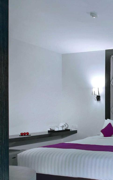 Postel nebo postele na pokoji v ubytování Quest Hotel Balikpapan by ASTON