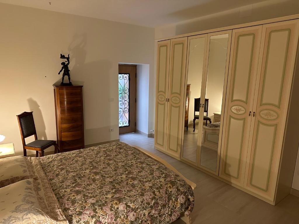 a bedroom with a bed and a dresser and a window at Dimora sul Corso in Acquasanta Terme
