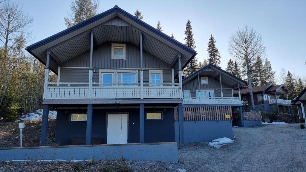 a large house with a porch and a driveway at Villa Magnolia 2 Himos in Jämsä