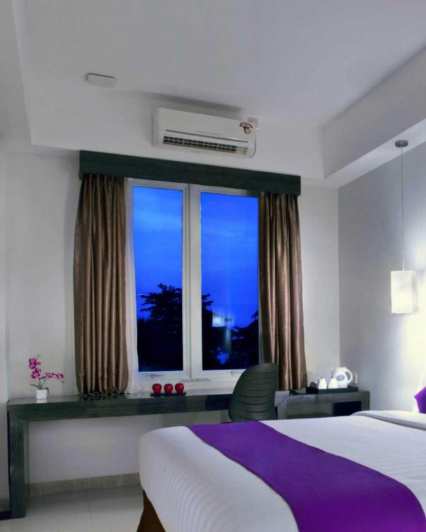 Postel nebo postele na pokoji v ubytování Quest Hotel Balikpapan by ASTON