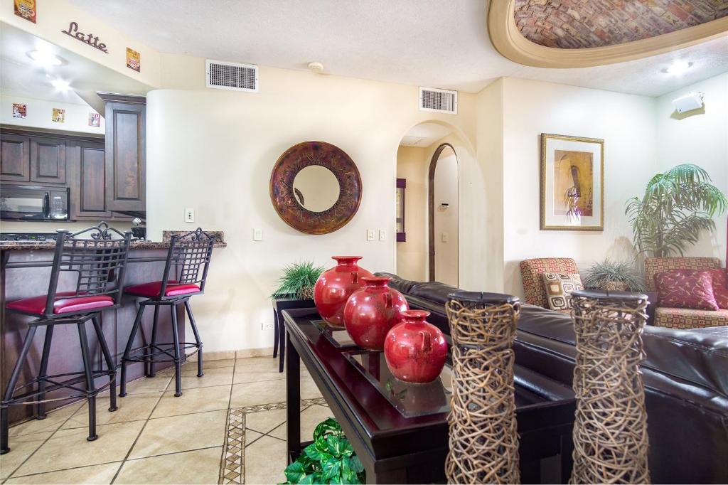 a living room with a counter with red vases on it at Bella Sirena in La Choya