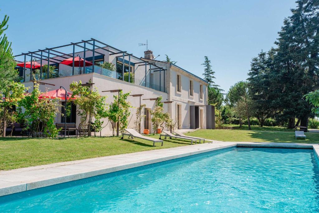 une maison avec une piscine devant une maison dans l'établissement Domaine de la Peyrine - Suite Mésange, à Carignan
