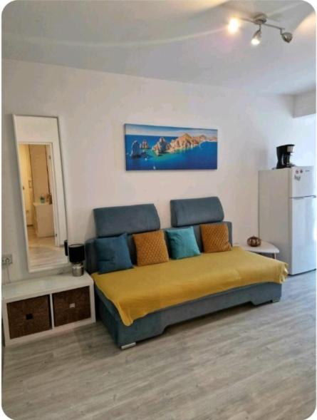 a bedroom with a bed with blue and orange pillows at Saturn Alfa Residence - 2 Rooms Apartment in Saturn