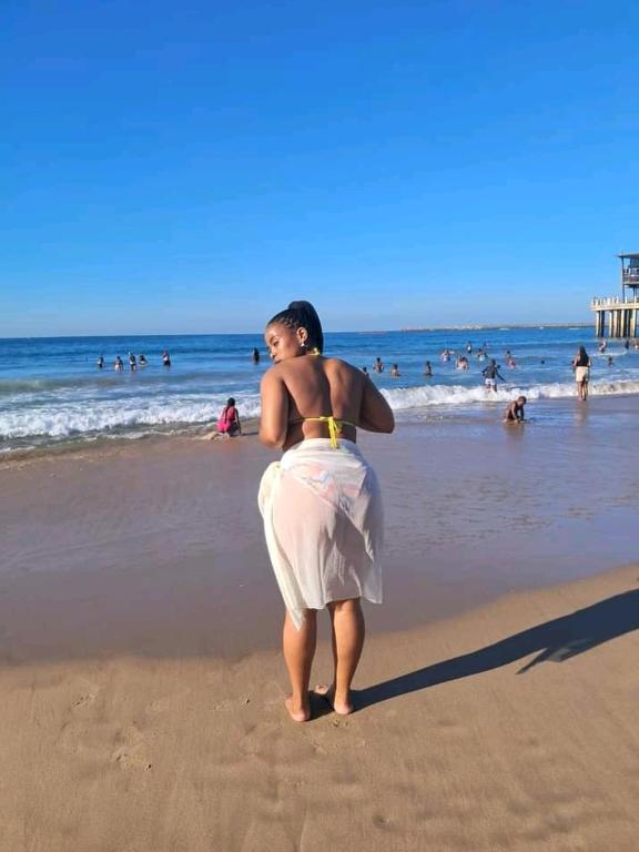 a woman is standing on the beach at Heavens stay in Vosburg