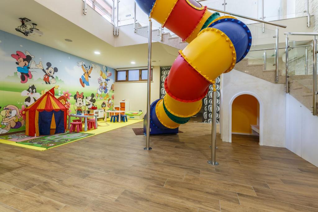 a play room with a large slide in the ceiling at Polidor Camping Resort in Poreč