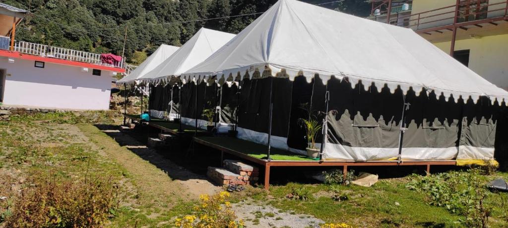 a group of tents sitting next to a building at Chopta Rock Hill Camp in Chopta
