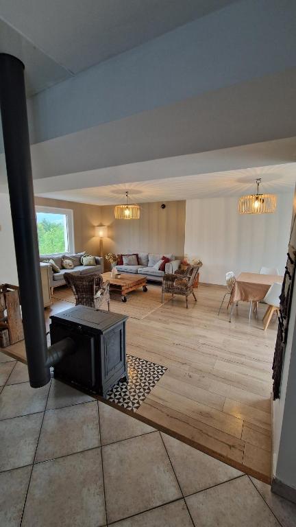 a living room with a fireplace in the middle of it at House, Pool and Mountains in Myans
