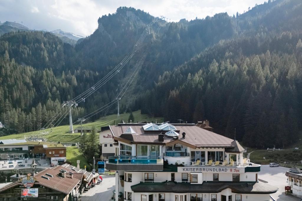 a view of a town with a mountain in the background at Hotel Neuhintertux in Tux